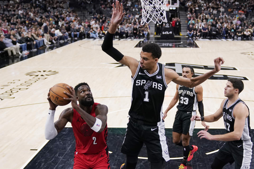 Portland Trail Blazers center Deandre Ayton (2) looks to shoot against San Antonio Spurs center Victor Wembanyama (1) during the first half of an NBA basketball game in San Antonio, Friday, Jan. 26, 2024. (AP Photo/Eric Gay)