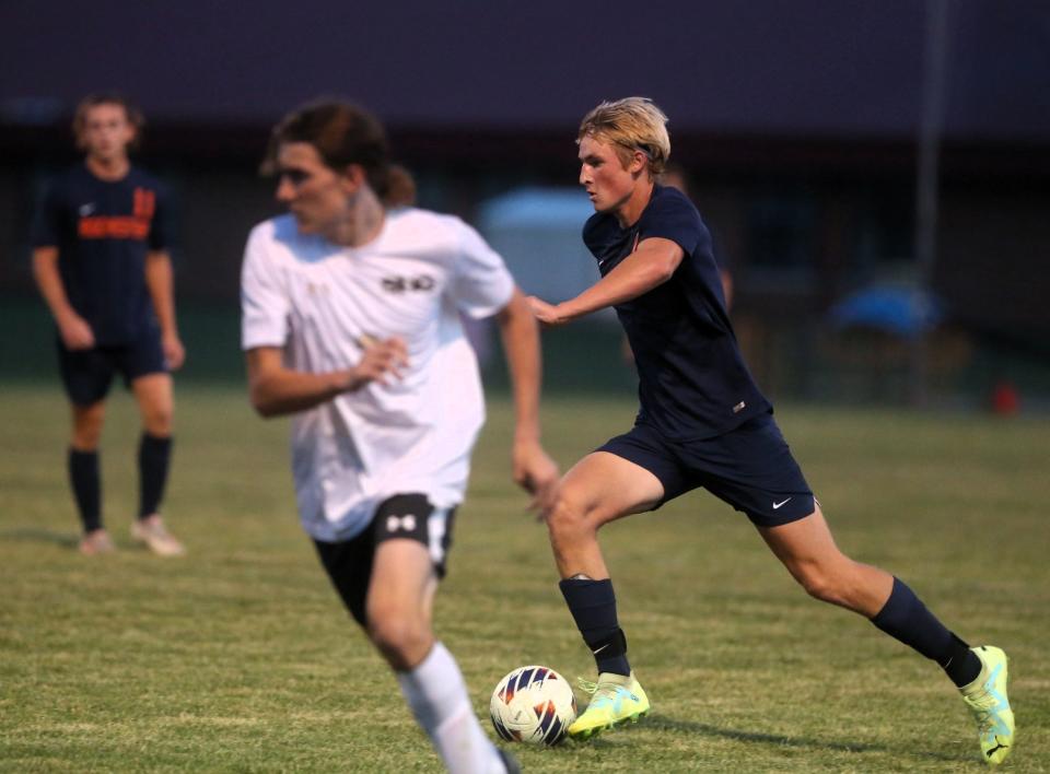 Rochester's Major Gibson pushes the ball during a Central State Eight Conference boys soccer match against Sacred Heart-Griffin on Tuesday, Sept. 19, 2023.