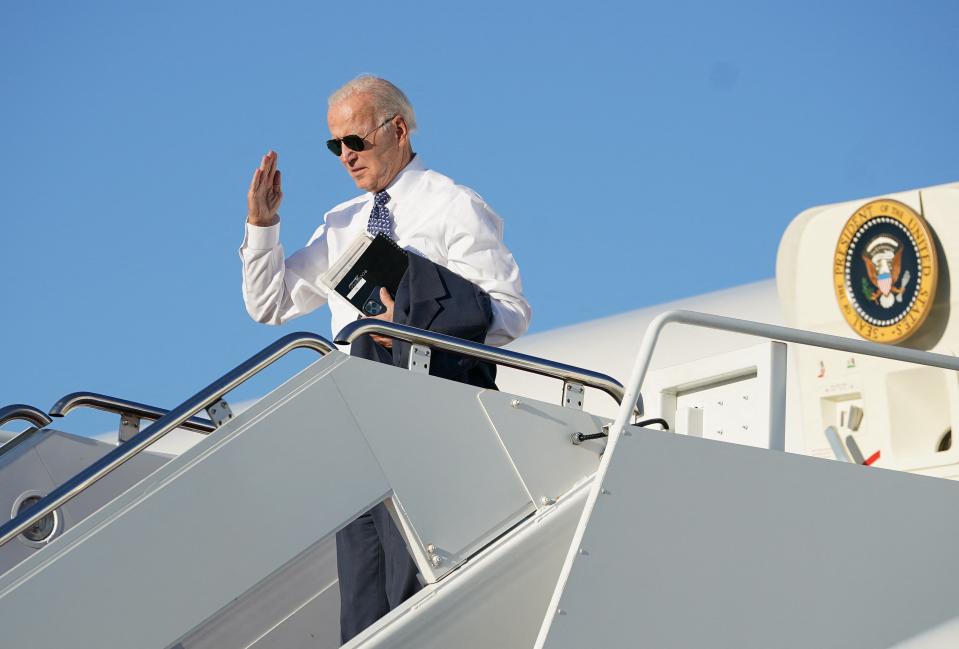 US President Joe Biden salutes as he boards Air Force One at Joint Base Andrews in Maryland, on 13 September 2022 (AFP via Getty Images)