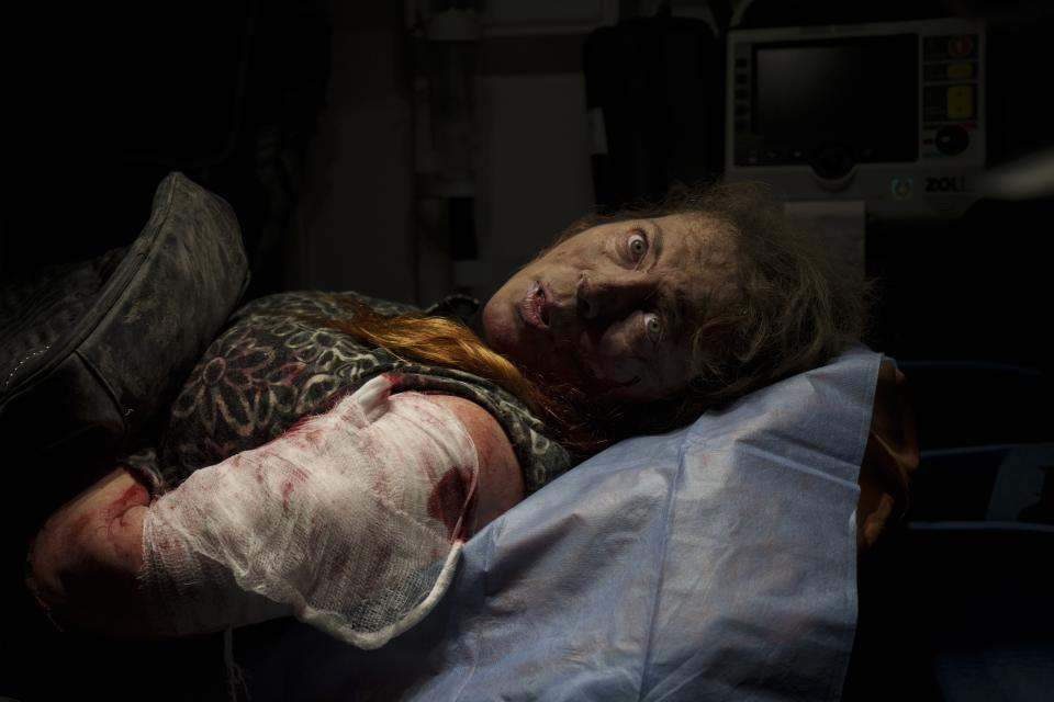 A resident wounded after a Russian attack lies inside an ambulance before being taken to a hospital in Kherson, southern Ukraine, Nov. 24, 2022. The image was part of a series of images by Associated Press photographers that was awarded the 2023 Pulitzer Prize for Breaking News Photography. (AP Photo/Bernat Armangue)