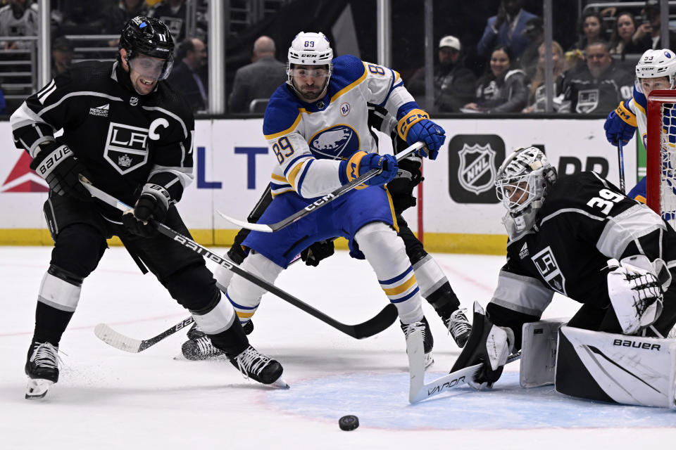 Los Angeles Kings center Anze Kopitar (11) stops a pass intended for Buffalo Sabres right wing Alex Tuch (89) in front of goaltender Cam Talbot (39) during the first period of an NHL hockey game in Los Angeles, Wednesday, Jan. 24, 2024. (AP Photo/Alex Gallardo)