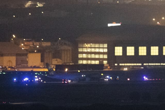 An Air Canada Boeing 767 aircraft is surrounded by safety vehicles