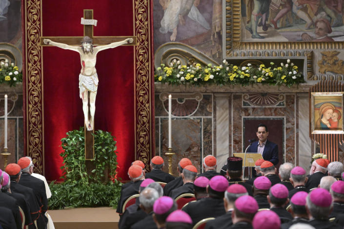 A survivor of sex abuse, who wished to remain anonymous, background right, delivers his testimony during a penitential liturgy attended by Pope Francis at the Vatican, Saturday, Feb. 23, 2019. The pontiff is hosting a four-day summit on preventing clergy sexual abuse, a high-stakes meeting designed to impress on Catholic bishops around the world that the problem is global and that there are consequences if they cover it up. (Vincenzo Pinto/Pool Photo Via AP)