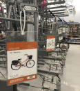 FILE-In this Tuesday, June 9, 2020 photo, bike display racks are empty at a Walmart in Falmouth, Maine. A bicycle rush has been brought on by the coronavirus pandemic. In the U.S., bicycle aisles at mass merchandisers like Walmart and Target have been swept clean, officials say, and independent shops are doing a brisk business and are selling out of low- to mid-range "family" bikes. (AP Photo/David Sharp)