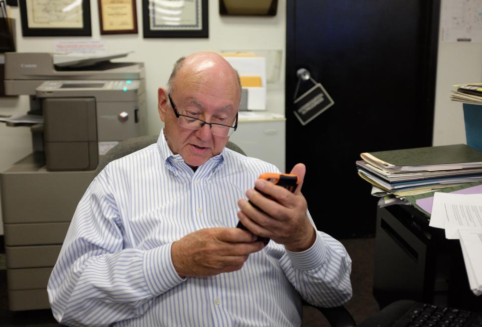 Jim Houck would check sports scores after editing major stories as he did here in this file photo.