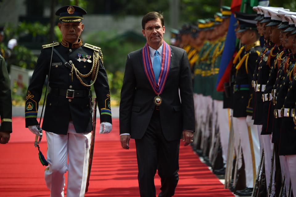 File Photo: US Secretary of Defense Mark Esper (R) reviews the honour guard during a welcome ceremony at the Department of Defense in Manila on November 19, 2019. (Photo: TED ALJIBE/AFP via Getty Images)