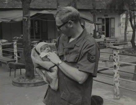 Kimberly Mitchell's father holding her.