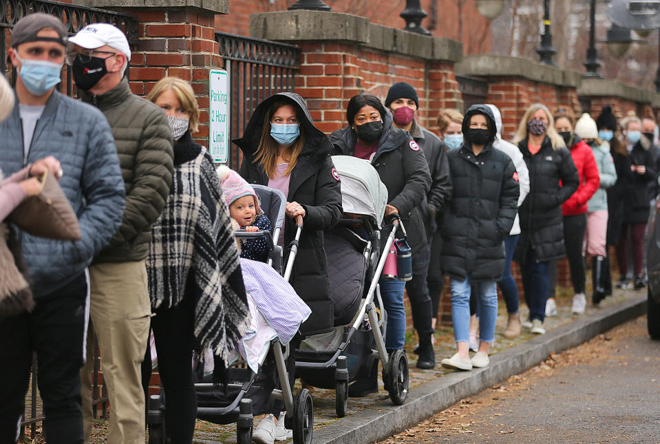 A long line formed at the Boston Public Library as antigen rapid test kits for COVID-19 were handed out free on December 22, 2021. (Photo by John Tlumacki/The Boston Globe via Getty)