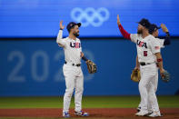 United States' Eddy Alvarez, center, and Eric Filia celebrate after a semi-final baseball game against South Korea at the 2020 Summer Olympics, Thursday, Aug. 5, 2021, in Yokohama, Japan. The United States won 7-2. (AP Photo/Sue Ogrocki)