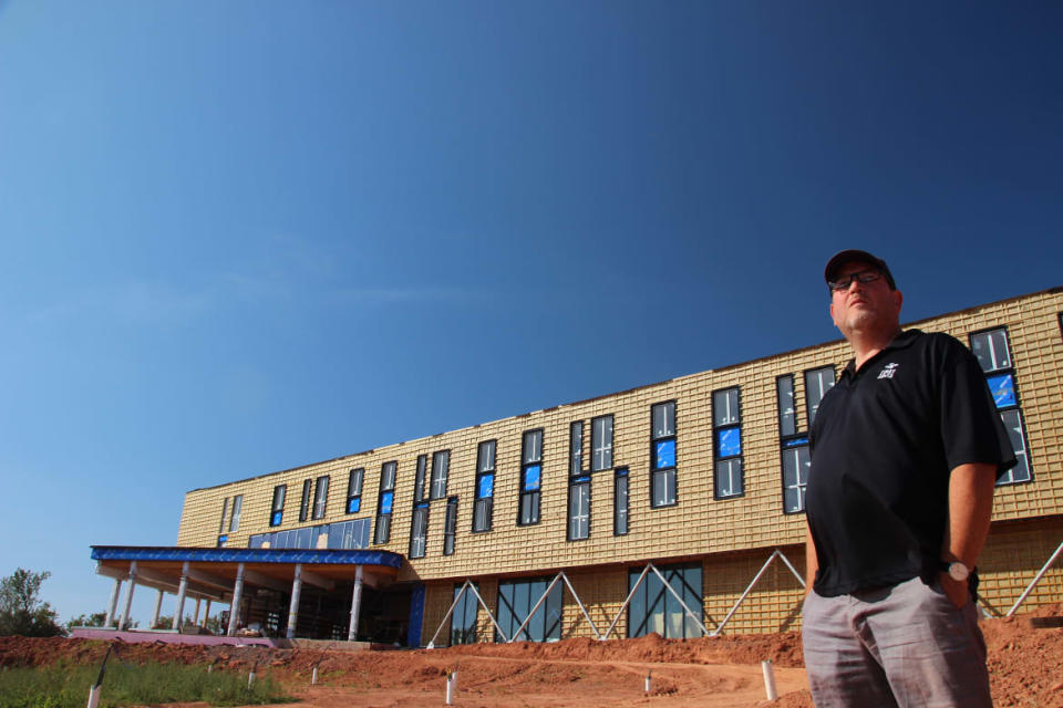 <div class="inline-image__caption"><p>Dr. Adam Fenech poses in front of the drone port that is under construction at Centre for Climate Change.</p></div> <div class="inline-image__credit">Russel Crosby</div>