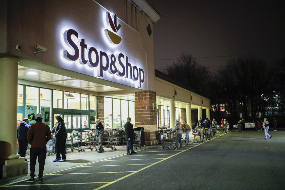 FILE - In this Friday, March 20, 2020 file photo, customers wait in line at a Stop & Shop supermarket that opened special morning hours to serve people 60-years and older due to coronavirus concerns, in Teaneck, N.J. The outbreak of the coronavirus has dealt a shock to the global economy with unprecedented speed as it continues to spread across the world. Stop & Shop will hire at least 5,000 new associates for regular part-time positions in its stores, distribution centers and delivery operations across New York, New Jersey, Connecticut, Massachusetts and Rhode Island. (AP Photo/John Minchillo, File)