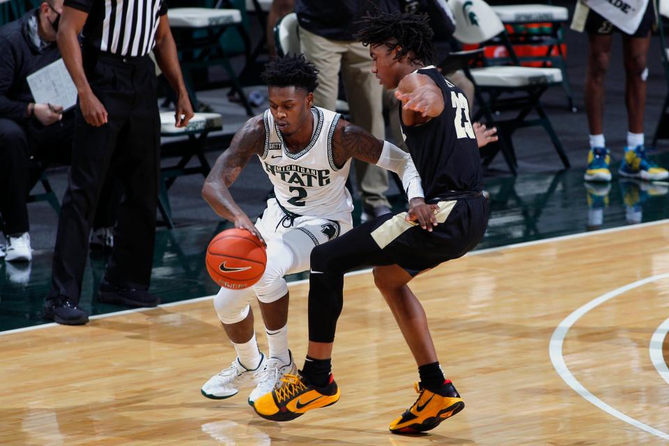 Michigan State's Rocket Watts, left, maneuvers against Purdue's Jaden Ivey (23) during the first half of an NCAA college basketball game Friday, Jan. 8, 2021, in East Lansing, Mich. (AP Photo/Al Goldis)