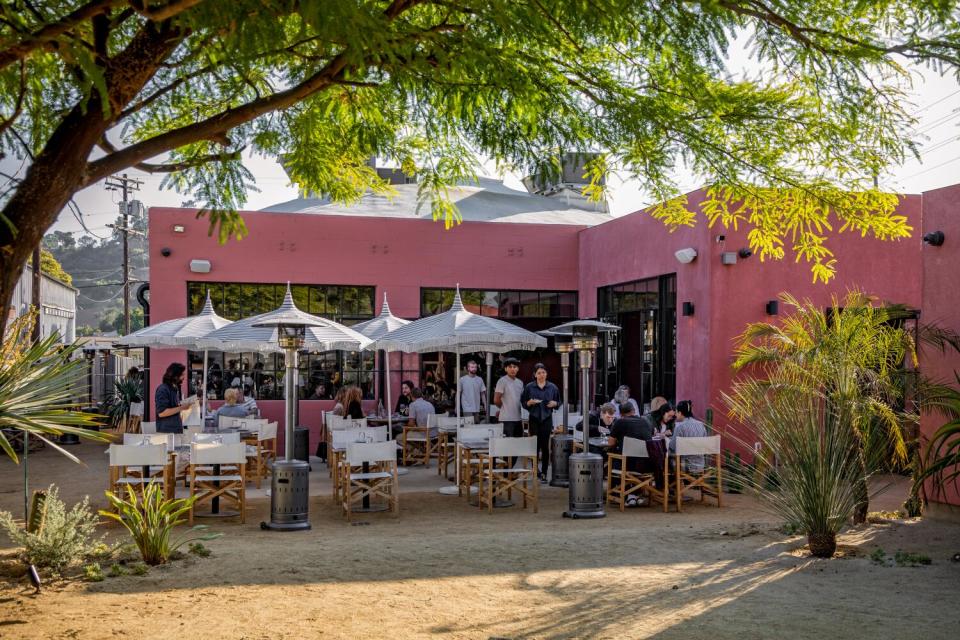 Tables and chairs under umbrellas on a restaurant's outdoor patio