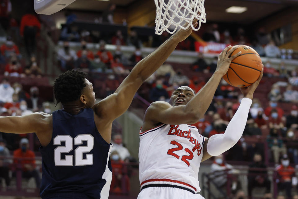 Ohio State's Malaki Branham, right, shoots over Penn State's Jalen Pickett during the second half of an NCAA college basketball game Sunday, Jan. 16, 2022, in Columbus, Ohio. (AP Photo/Jay LaPrete)