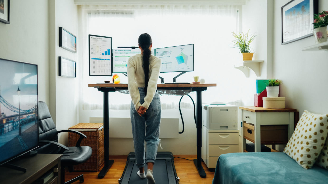 Woman working from home at standing desk is walking on under desk treadmill, Sperax Walking Pad,3 in 1 Treadmill Foldable, Under Desk Treadmill, Treadmills for Home