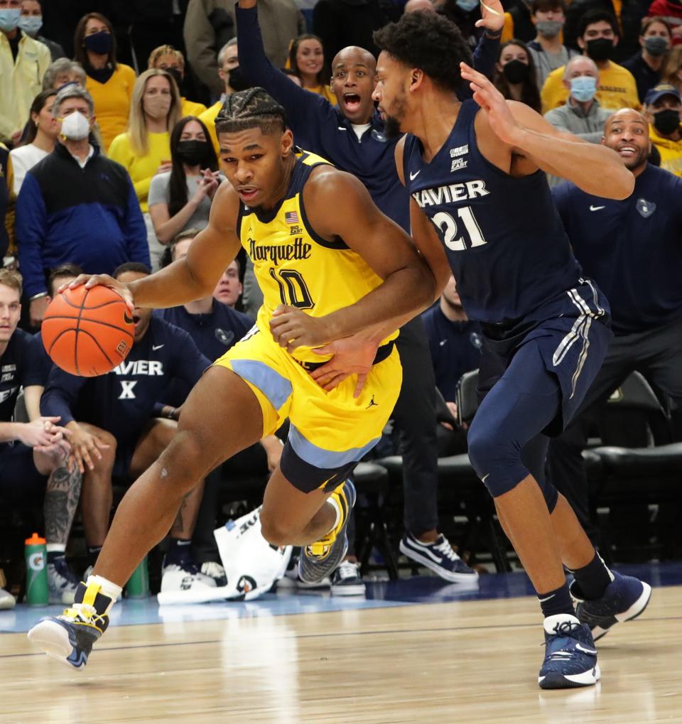 Marquette forward Justin Lewis  gets around Xavier forward Jerome Hunter during the first half  Sunday at Fiserv Forum. Lewis finished with a team-high 20 points.