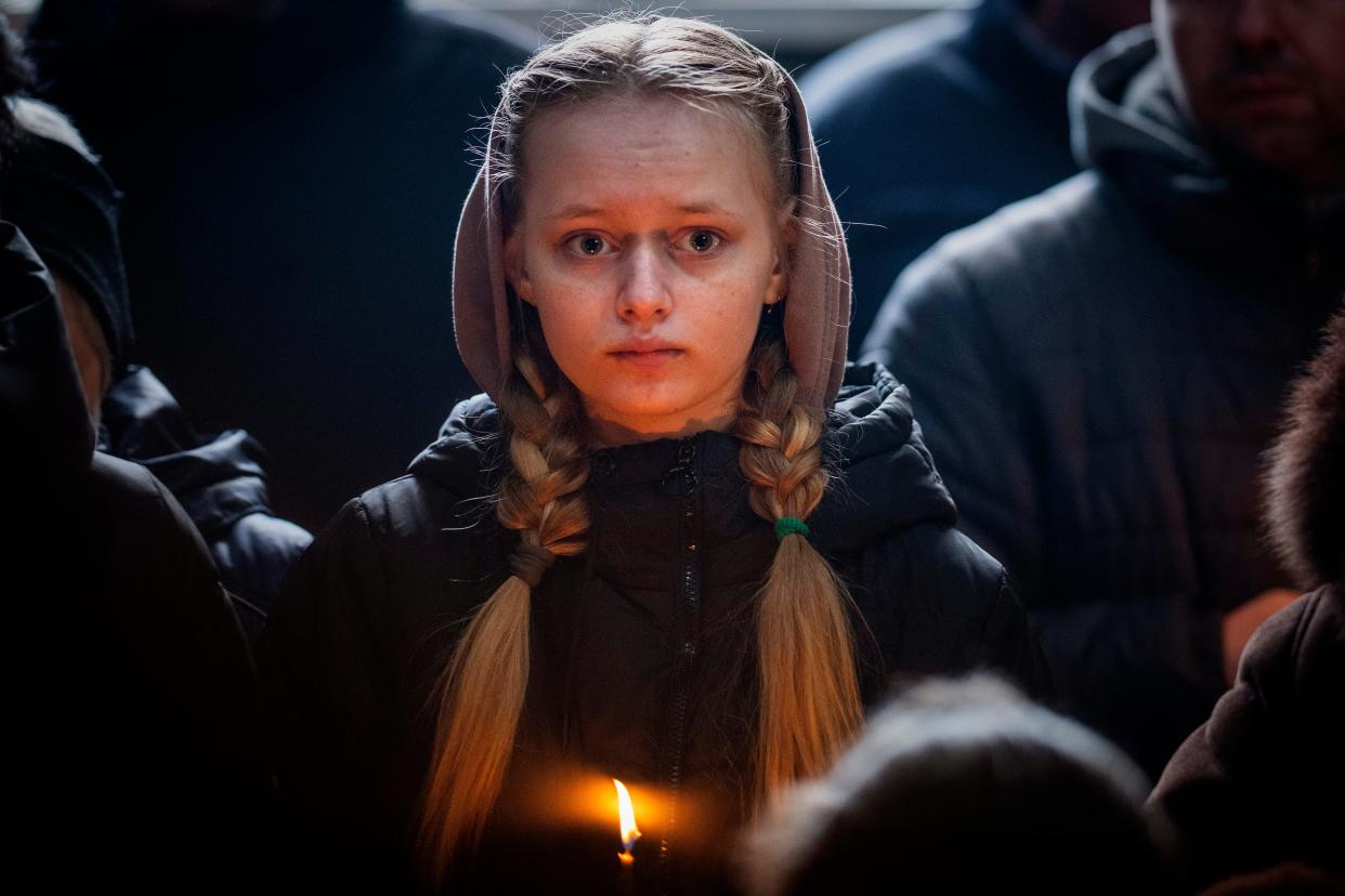 A relative holds a candle during Roman Shevchenko’s funeral in Bila Tserkva, near Kyiv (Copyright 2023 The Associated Press. All rights reserved)