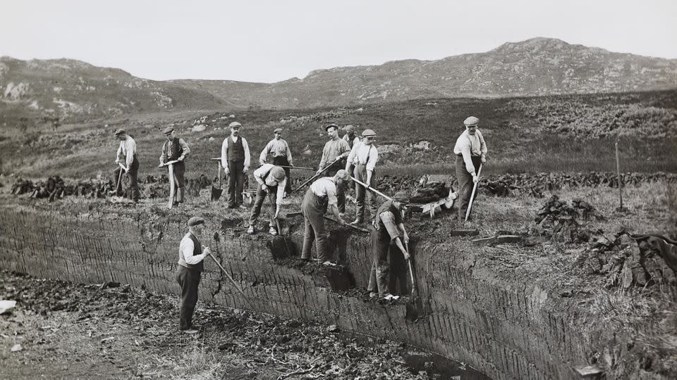 Islay’s tradition of whisky-making goes back generations. Pictured here, circa 1912, are workers hand-cutting peat that is burned in the kilns to dry the barley. - The Glenmorangie Company