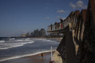 People enjoy a sunny day in Tel Aviv, Israel, Thursday, Dec. 2, 2021. Residents of Israel's seaside metropolis Tel Aviv have for years complained of how expensive it is, with living costs taking a chunk out of their paychecks. A report released Wednesday, Dec. 1, 2021, by the Economist Intelligence Unit, a research group linked to the Economist magazine, said Tel Aviv has emerged as the most expensive city to live in. (AP Photo/Oded Balilty)