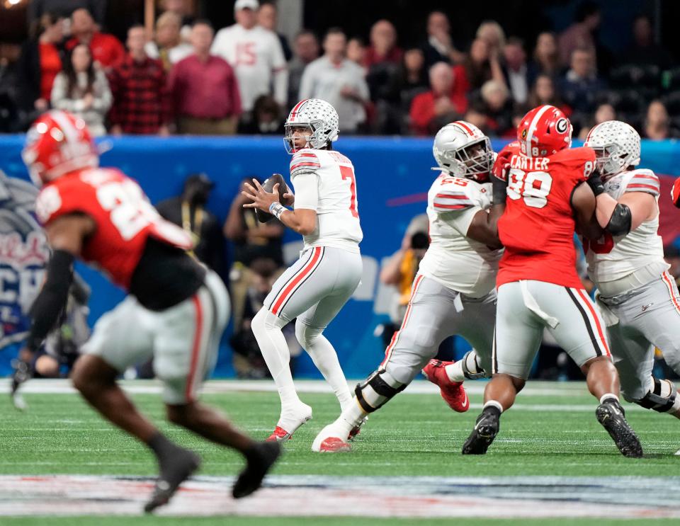 Dec 31, 2022; Atlanta, Georgia, USA; Ohio State Buckeyes quarterback C.J. Stroud (7) drops back to pass against Georgia Bulldogs during the first quarter of the Peach Bowl in the College Football Playoff semifinal at Mercedes-Benz Stadium. 