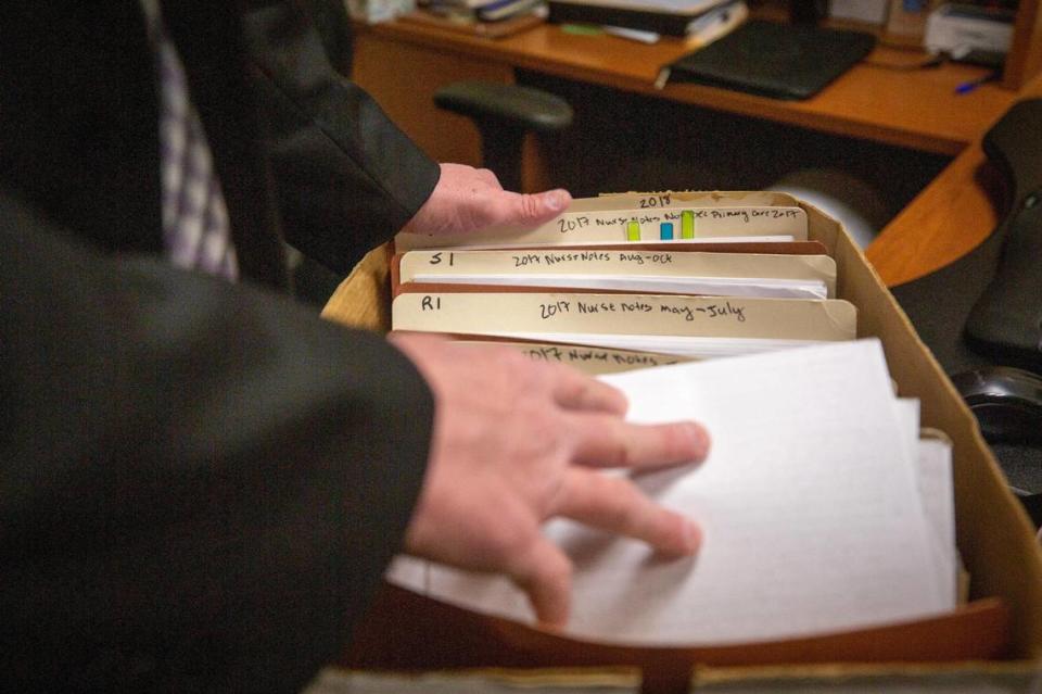 Tarrant County Detective Mike Weber flips through a box of files for one medical child abuse case at his office in the Tarrant County Plaza Building on Feb. 25, 2023. Weber has investigated 35 claims of medical child abuse, otherwise known as munchausen syndrome by proxy.