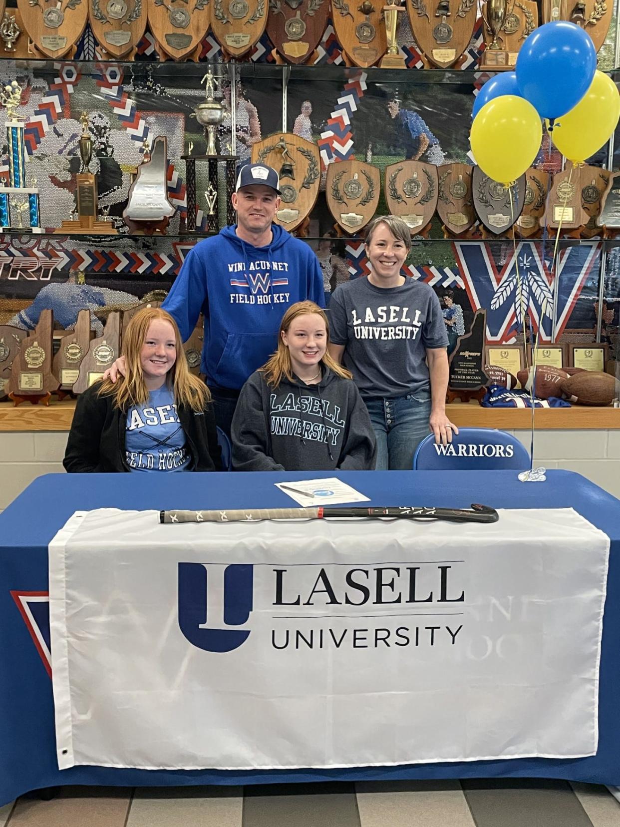 Winnacunnet's Amelia McAfe, front right, sits with her sister, Fiona; mom, Kate; and dad, Bryan, after announcing she will continue her academics and field hockey career next year at Lasell University in Newton, Massachusetts.