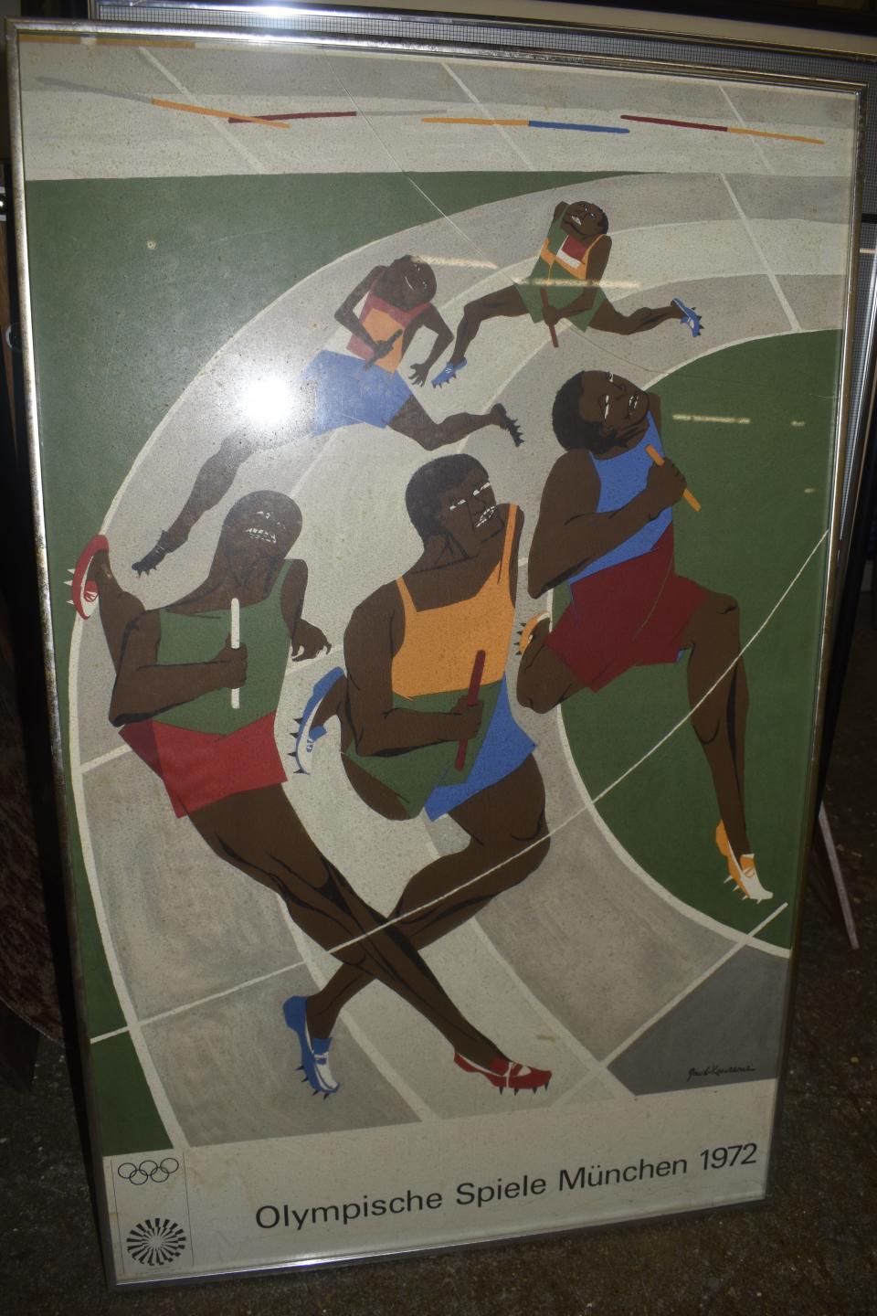 An auction appraiser said this signed poster by the late African American artist Jacob Lawrence from the 1972 Munich Olympic Games, in a metal frame under broken glass, is likely worth $700 to $900 as is. Volunteers initially had intended to reframe the poster and sell it for $50.