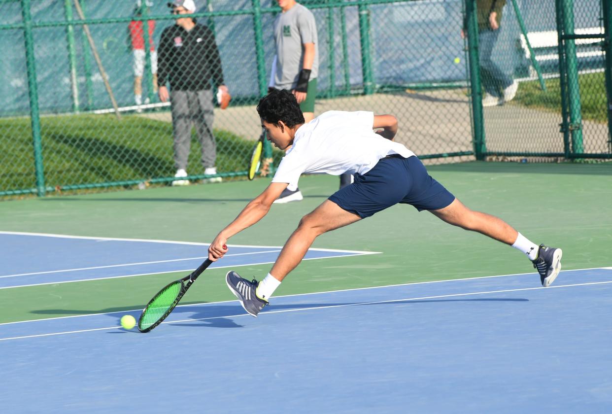 Avi Mahajan of Seven Hills digs for a service save in the first singles at Flight A of the GCTCA Coaches Classic Tennis Tournament, Mason High School, April 27.