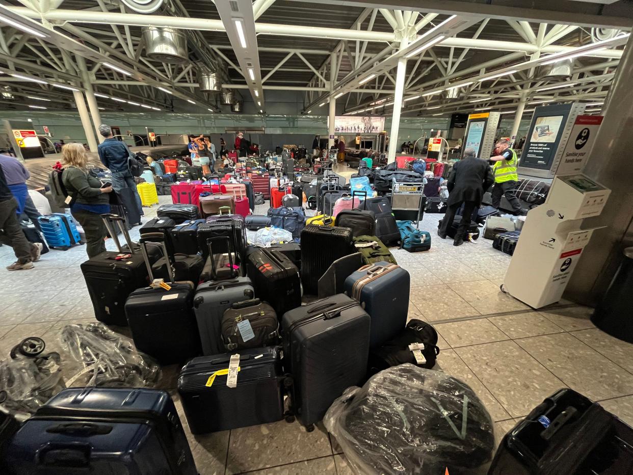 Suitcases are seen uncollected at Heathrow's Terminal Three bagage reclaim, west of London on July 8, 2022. - British Airways on Wednesday axed another 10,300 short-haul flights up to the end of October, with the aviation sector battling staff shortages and booming demand as the pandemic recedes.