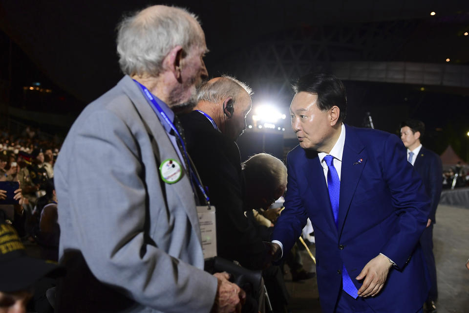 South Korean President Yoon Suk Yeol, right, shakes hands with Korean War veterans during the ceremony of the 70th Anniversary of the Korean War armistice agreement on Thursday, July 27, 2023, in Busan, South Korea. (Kim Min-Hee/Pool Photo via AP)