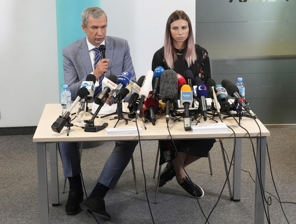 Belarusian dissident in Poland, Pavel Latushka, left, and Belarusian Olympic sprinter Krystsina Tsimanouskaya, right, who came to Poland fearing reprisals at home after criticizing her coaches at the Tokyo Games, talk to journalists in Warsaw, Poland, Thursday, Aug. 5, 2021. (AP Photo/Czarek Sokolowski)