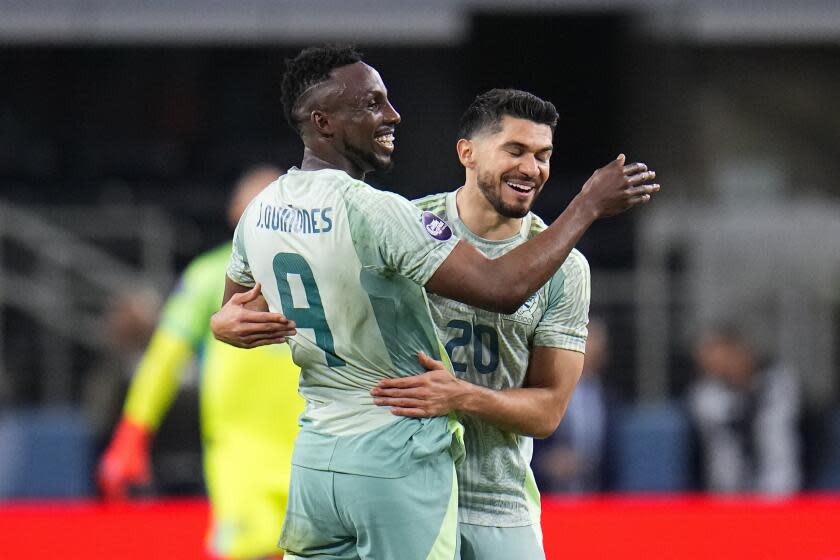 Mexico's Julian Quinones, left, celebrates with teammate Henry Martin after scoring a goal against Panama during the first half of a CONCACAF Nations League semifinals soccer match, Thursday, March 21, 2024, in Arlington, Texas. (AP Photo/Julio Cortez)