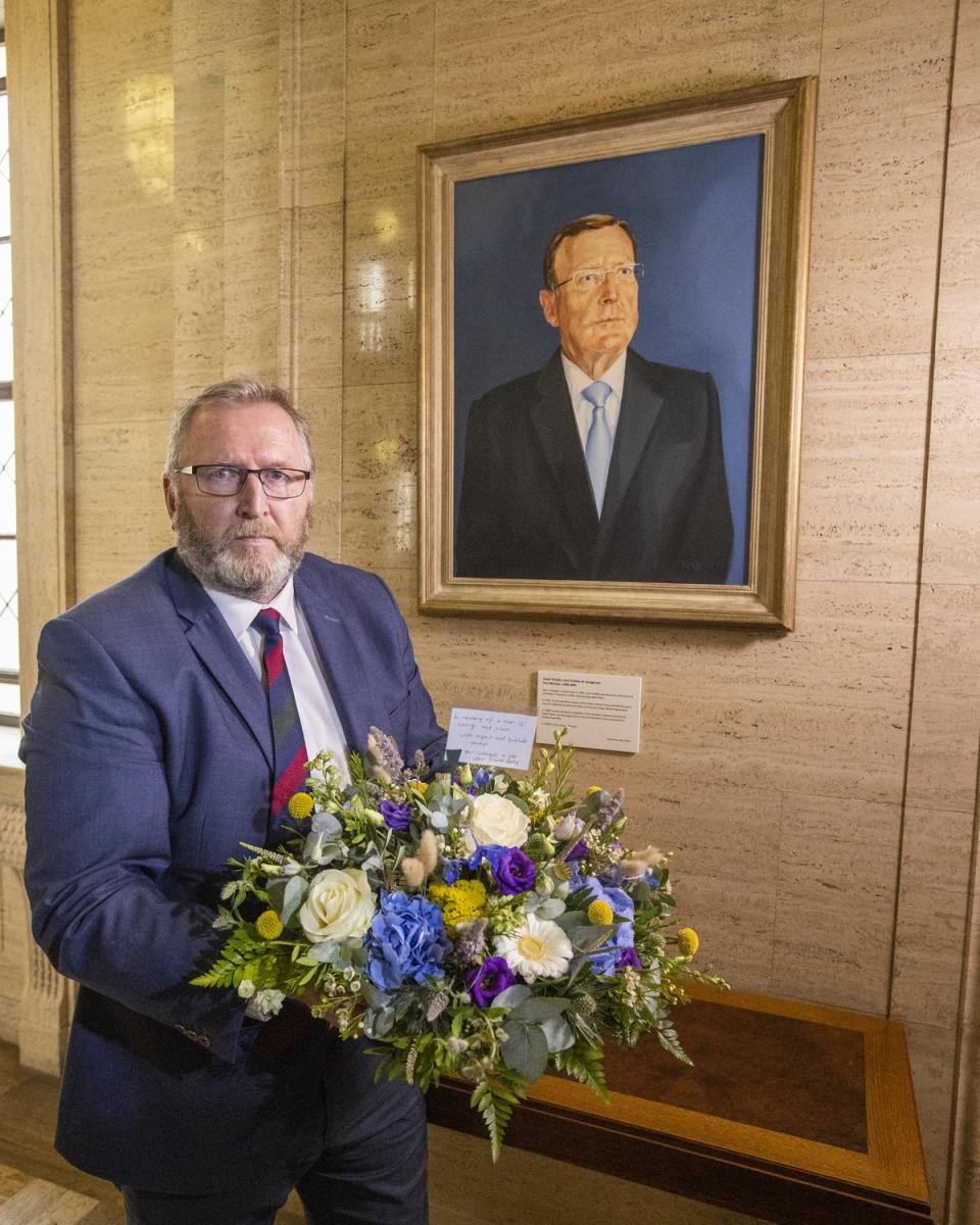 Doug Beattie, leader of the Ulster Unionist Party (UUP) lays a wreath under the portrait of the party’s former leader David Trimble, in the Great Hall of Parliament Buildings at Stormont (Liam McBurney/PA) (PA Wire)