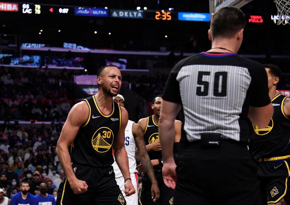 Stephen Curry of the Golden State Warriors reacts angrily to referee Gediminas Petraitis and complains of being fouled by Terance Mann of the Los Angeles Clippers. He received a technical.