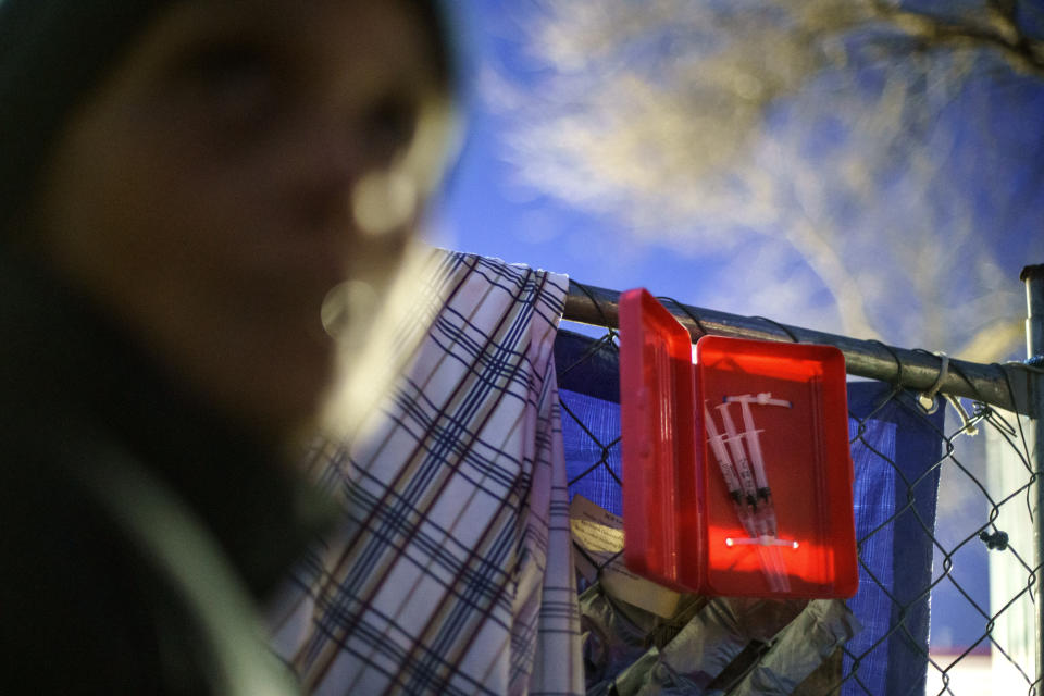 Prefilled syringes of naloxone are ready for use outside the gate where dozens of Native women are living in tents in the lot of an abandoned gas station in south Minneapolis, Monday, Nov. 15, 2021. In Minnesota, as across the country, drug dealers now cut nearly every drug on the street with fentanyl, a cheap and deadly synthetic opioid so potent the equivalent of a sugar packet can make 40 doses, said Joe Kleszyk, the commander of a drug task force in northern Minnesota. "It's a game of Russian roulette," he said. (AP Photo/David Goldman)