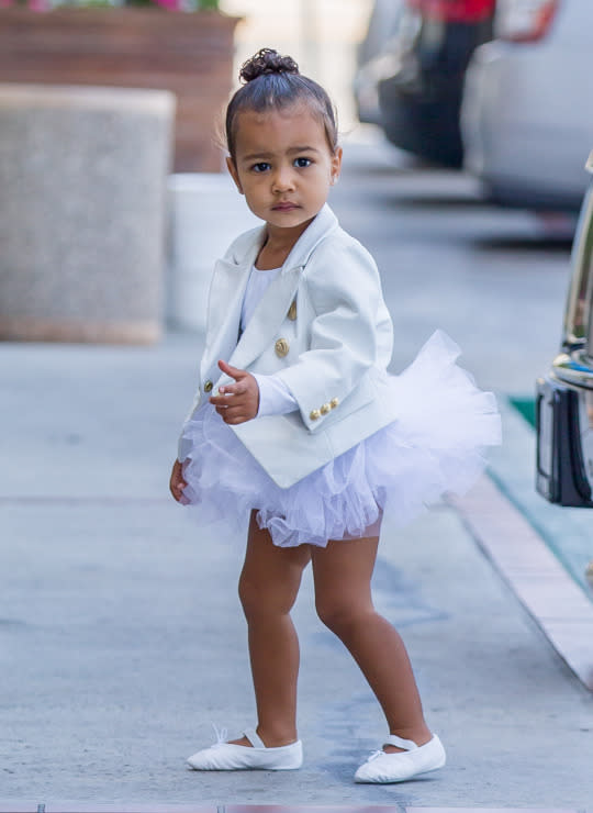 <p>We love it when North breaks out her custom Balmain jackets. In November 2014, mom Kim shared the gift from designer Olivier Rousteing via Instagram. He’d made the then 16-month-old North three different versions. Later that month, she wore the white one with a denim skirt. But on Thursday, she went for a ballerina-inspired look while out and about in Los Angeles, Calif. North paired the white blazer with gold buttons with a matching white leotard and ballet flats (because she’s far too cool for pink). Her only accessories? A topknot and diamond studs. And this is just her rehearsal look! We can’t wait what custom look Nori shows off come recital time!</p>