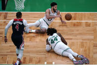 Boston Celtics forward Jayson Tatum (0) scrambles after the ball as center Robert Williams III (44) falls to the floor after a rebound during the first half of an NBA basketball Eastern Conference play-in game Tuesday, May 18, 2021, in Boston. At left is Washington Wizards guard Russell Westbrook. (AP Photo/Charles Krupa)