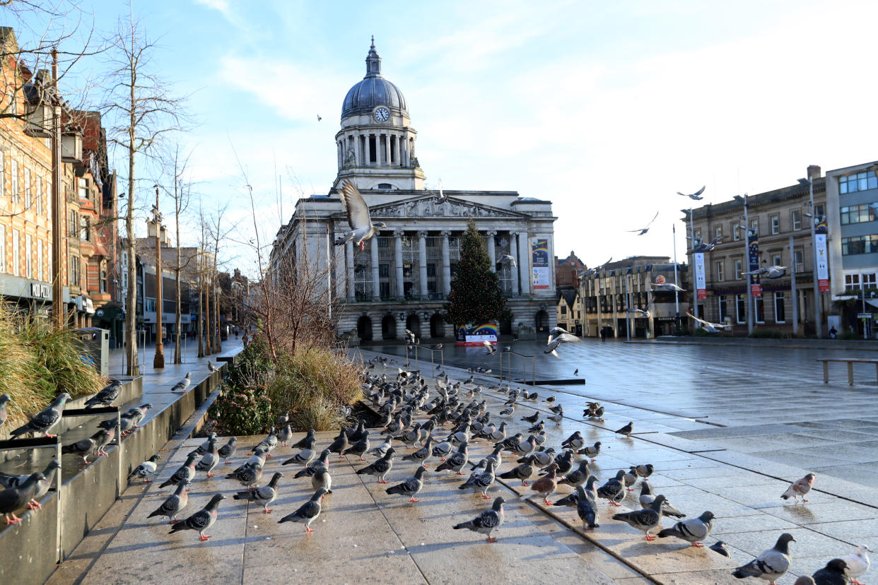 Pigeons in an empty Nottingham city centre. More than three quarters of England's population is being ordered to stay at home to stop the spread of coronavirus.