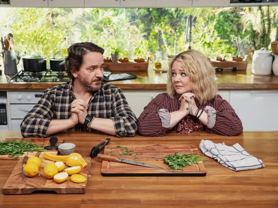 Ben Falcone as Clark Thompson, Melissa McCarthy as Amily Luck in episode 107 of God’s Favorite Idiot