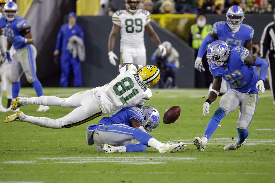 Detroit Lions defensive back Tracy Walker, bottom, and defensive back Tavon Wilson (32) break up a pass intended for Green Bay Packers wide receiver Geronimo Allison (81) during the second half of an NFL football game Monday, Oct. 14, 2019, in Green Bay, Wis. (AP Photo/Mike Roemer)