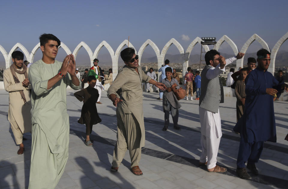 Afghans dance during Independence Day celebrations in Kabul, Afghanistan, Monday, Aug. 19, 2019. Afghanistan's president vowed to eliminate all safe havens of the Islamic State group as the country marks a subdued 100th Independence Day after a horrific wedding attack claimed by the local IS affiliate. (AP Photo/Nishanuddin Khan)