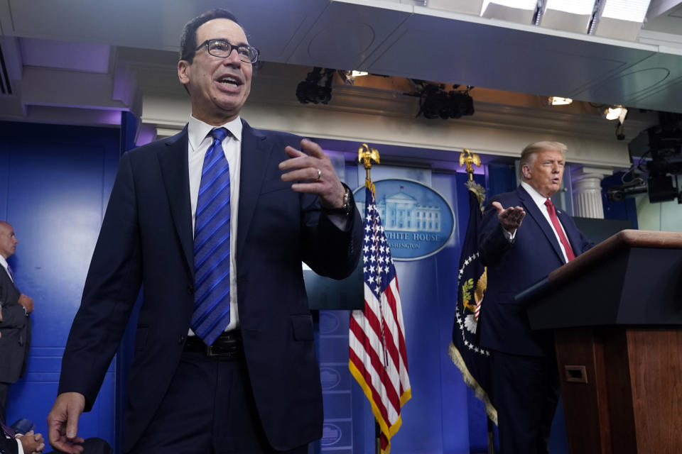 President Donald Trump listens as Treasury Secretary Steven Mnuchin speaks at a news conference in the James Brady Press Briefing Room at the White House, Monday, Aug. 10, 2020, in Washington. (AP Photo/Andrew Harnik)