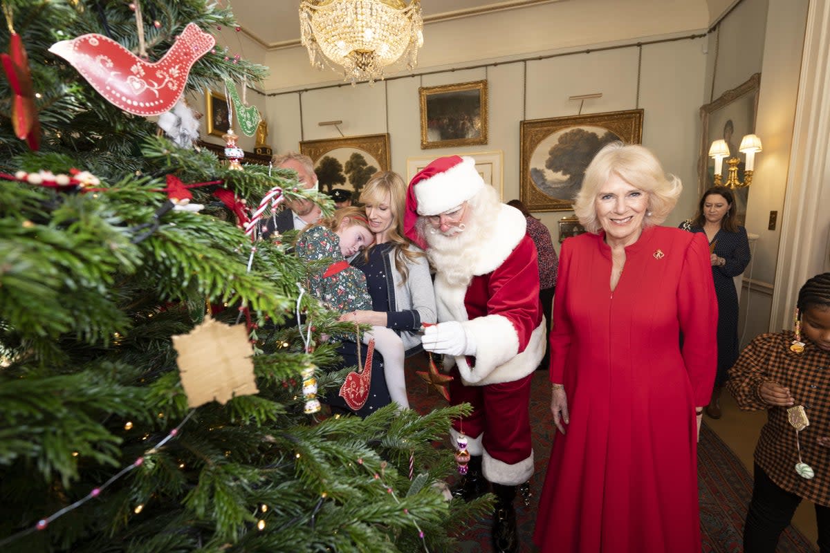 The Queen Consort, accompanied by children supported by Helen and Douglas House and Roald Dahl’s Marvellous Children’s Charity, decorate the Christmas tree at Clarence House in London (Paul Grover/Daily Telegraph/PA) (PA Wire)