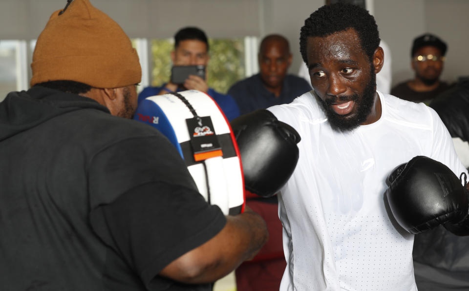 Undefeated WBO welterweight champion Terence Crawford (R) hits a pad held by trainer Brian “BoMac” McIntyre during a media workout July 19 at the UFC Apex in Las Vegas. (Photo by Steve Marcus, Getty Images)