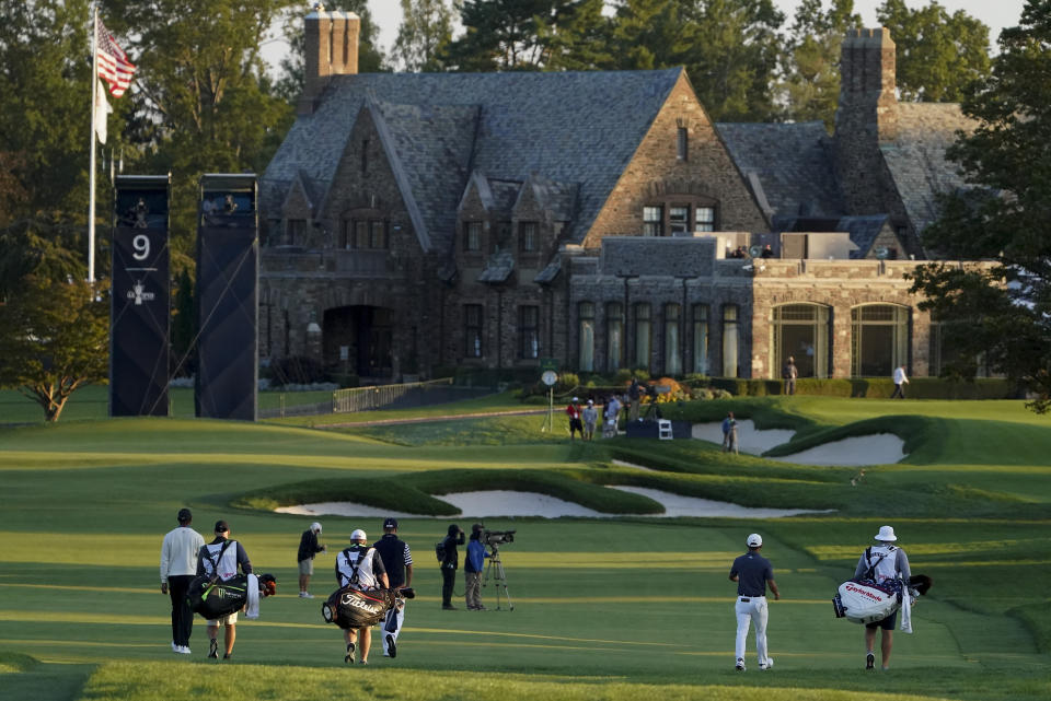 Tiger Woods, of the United States, far left, Justin Thomas, of the United States, center, and Collin Morikawa, approach the ninth green during the second round of the US Open Golf Championship, Friday, Sept. 18, 2020, in Mamaroneck, N.Y. (AP Photo/John Minchillo)