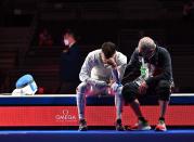 <p>Italy's Daniele Garozzo (L) is consolate by his coach Fabio Maria Galli after loosing against Hong Kong's Cheung Ka Long in the mens individual foil gold medal bout during the Tokyo 2020 Olympic Games at the Makuhari Messe Hall in Chiba City, Chiba Prefecture, Japan, on July 26, 2021. (Photo by Fabrice COFFRINI / AFP) (Photo by FABRICE COFFRINI/AFP via Getty Images)</p> 