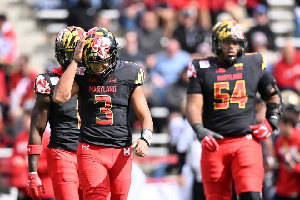 Maryland quarterback Taulia Tagovailoa, left, reacts after throwing an interception against Purdue in the first half of an NCAA college football game, Saturday, Oct. 8, 2022, in College Park, Md. (AP Photo/Gail Burton)