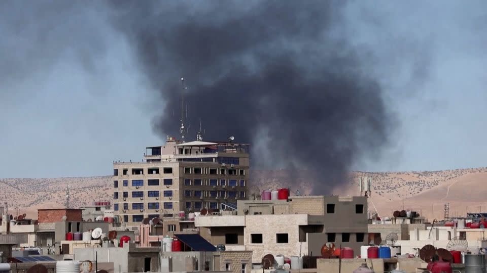 Smoke rises over buildings from a reported drone strike in Qamishli, northeastern Syria. - Reuters