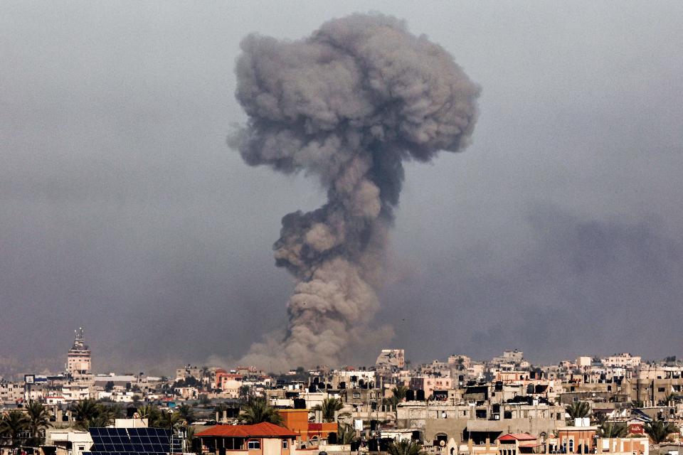 A smoke plume erupts over Khan Yunis from Rafah in the southern Gaza strip during Israeli bombardment on Jan. 8, 2024.