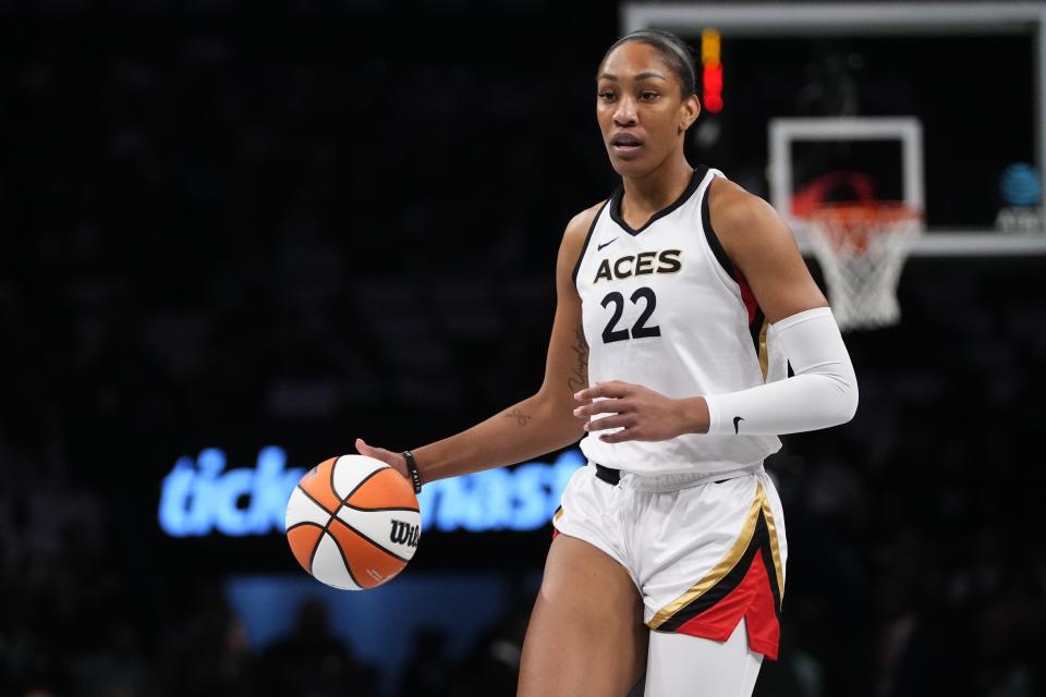 FILE - Las Vegas Aces' A'ja Wilson (22) looks to pass during the first half in Game 3 of a WNBA basketball final playoff series against the New York Liberty Sunday, Oct. 15, 2023, in New York. Wilson, Breanna Stewart and Brittney Griner will be back on the courts chasing another WNBA title when camps open on Sunday, April 28. (AP Photo/Frank Franklin II, File)